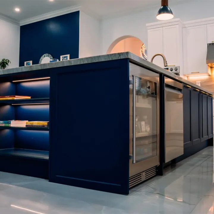 Miami Residence Kitchen with white cabinets and a blue island.