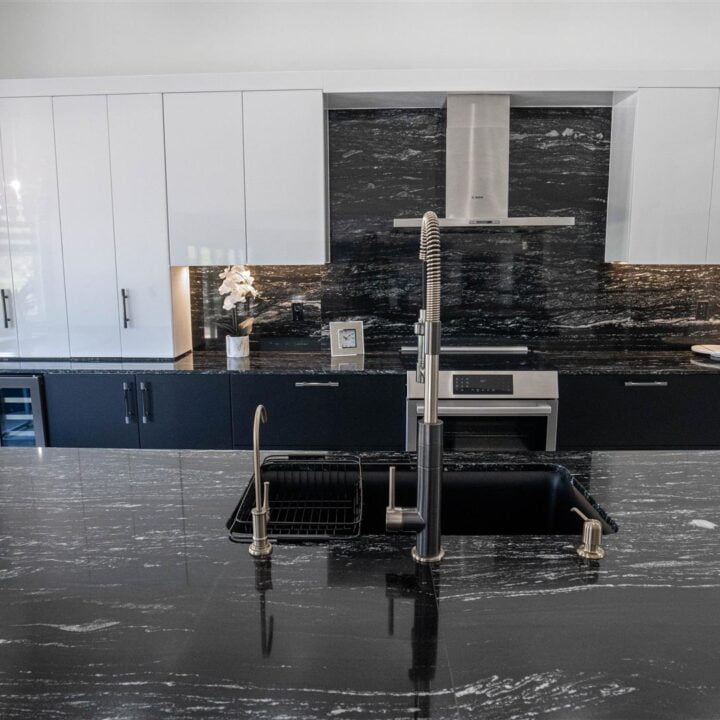 A Pembroke Pines kitchen featuring black granite counter tops and stainless steel appliances.