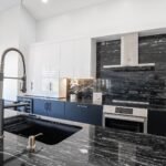 A black and white kitchen with marble counter tops located in Pembroke Pines.