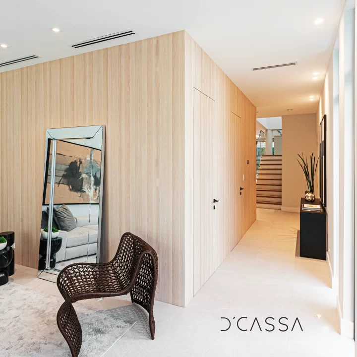 A living room with wooden walls and a mirror.