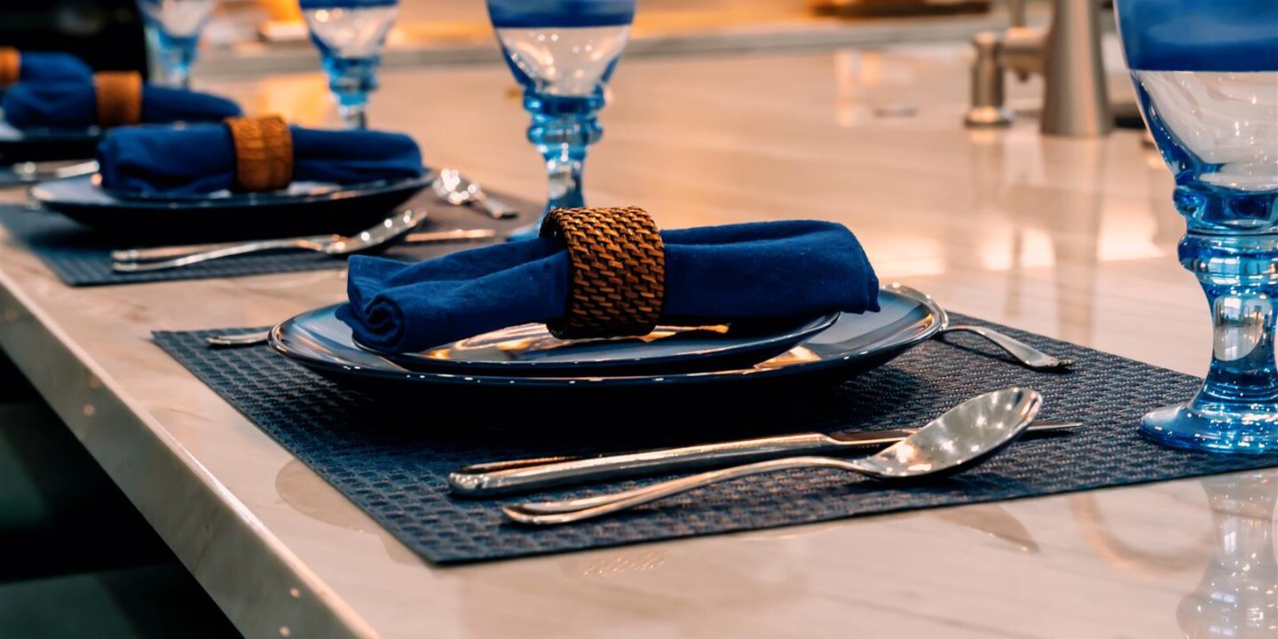 A blue place setting on a table.