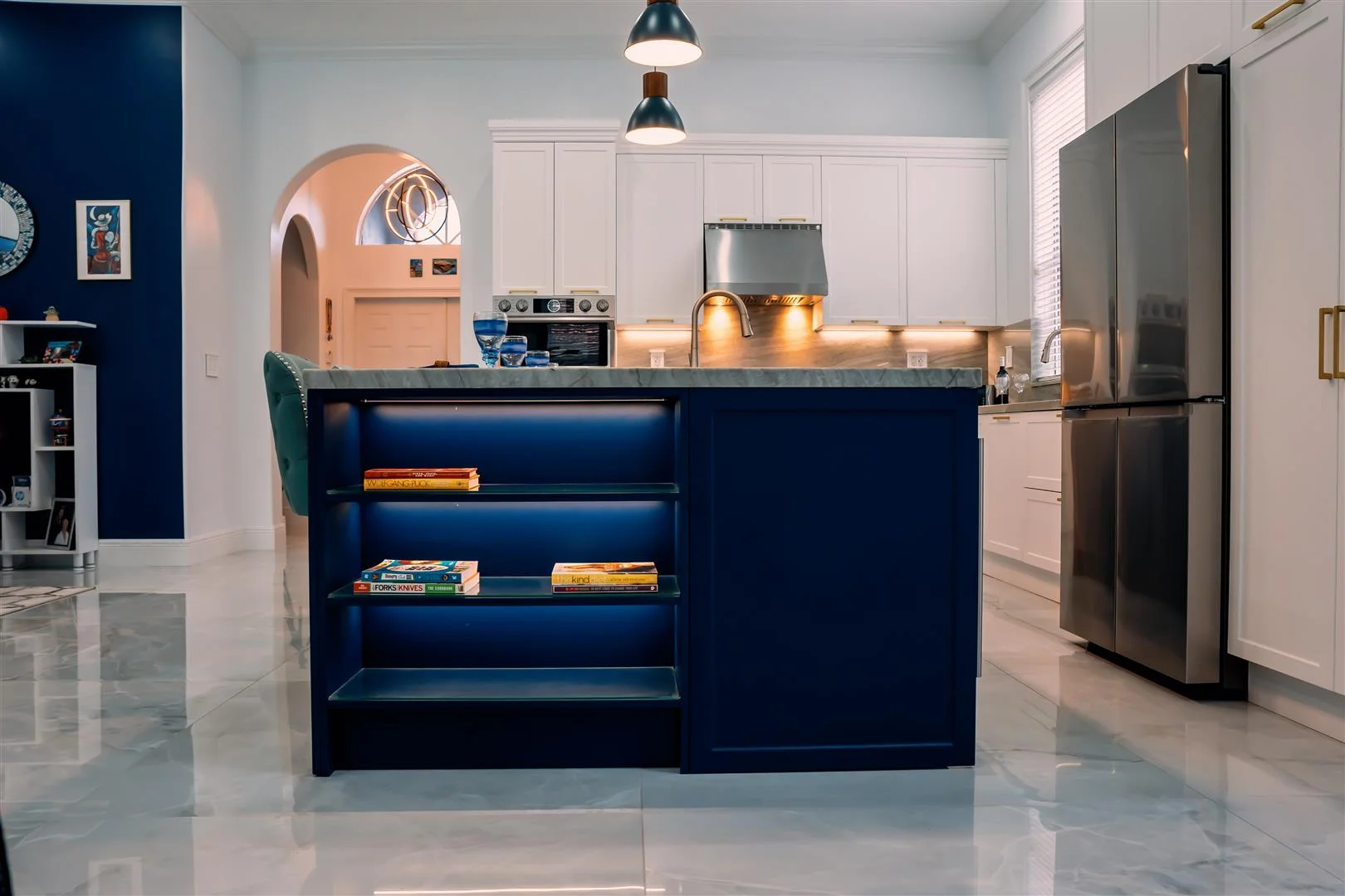 A kitchen with a blue island and white cabinets. Miami