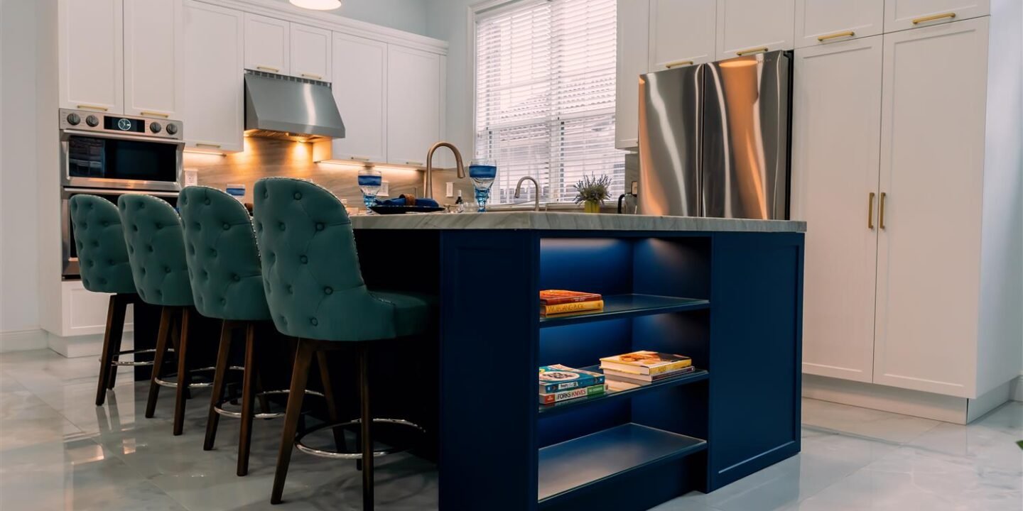 A kitchen with a blue island and blue chairs.