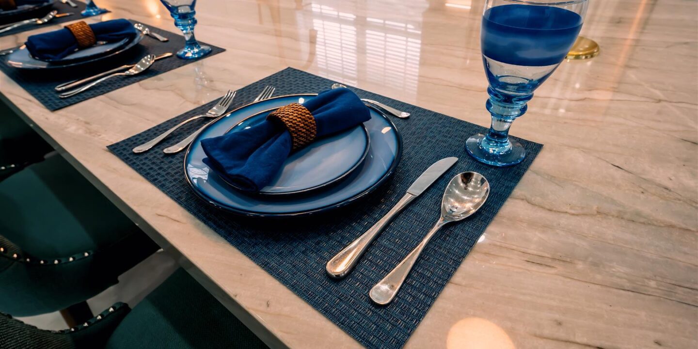 A blue place setting on a table.