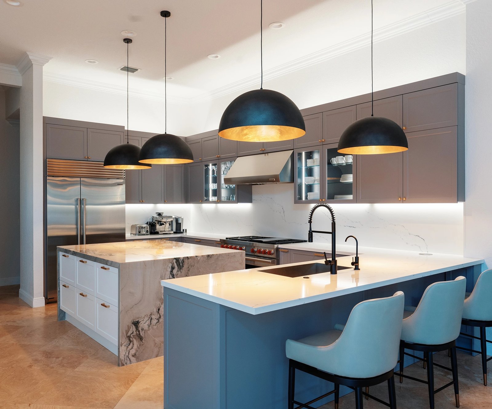 A modern kitchen with a large island showcasing the best ways to use various cabinet materials.