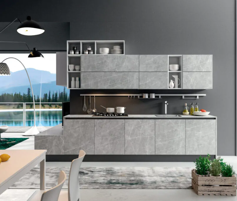 Modern kitchen with gray cabinets, large windows, and scenic view.